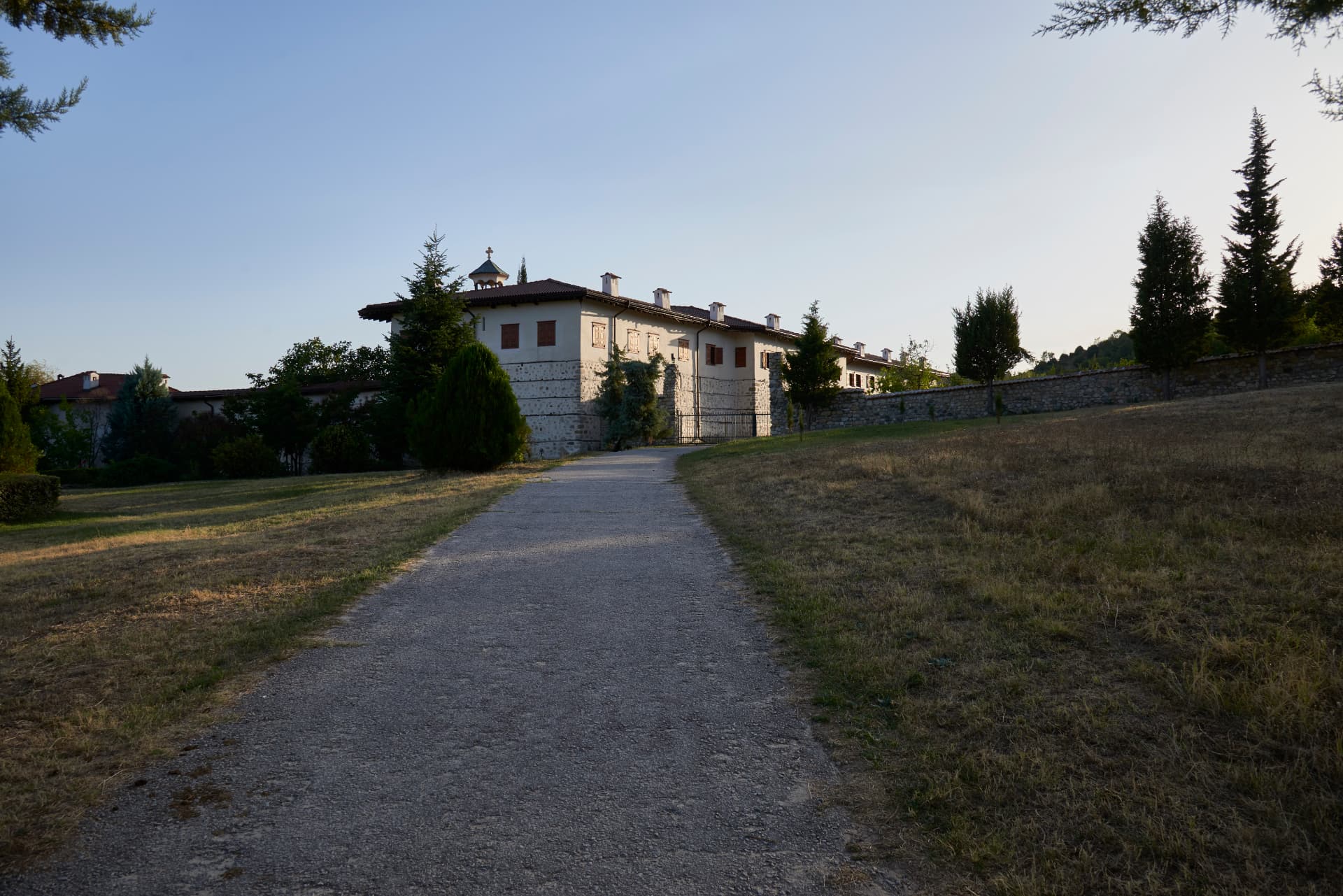 A path leading across the grounds towards Rozhen Monastery.