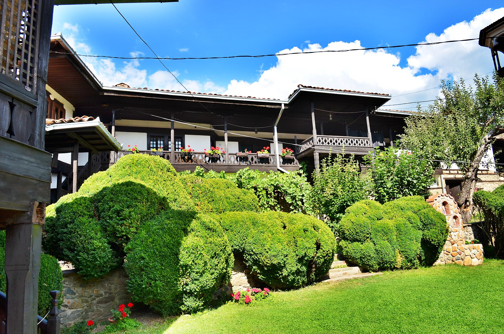 Clipped shrubs and wooden galleries in the courtyard of St Michael the Archangel Monastery, Berovo.