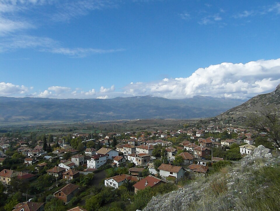 Houses in Ilindentsi with a broad valley and distant mountains beyond.